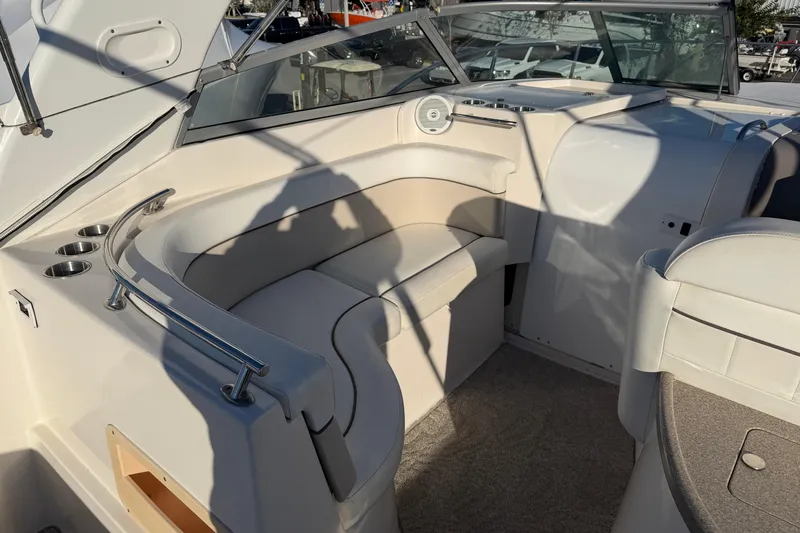 Slide: The Image of 2007 Rinker EX 370 boat interior with beige seating and cup holders. - 9