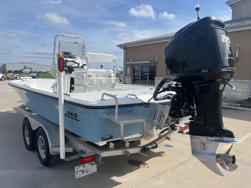 Slide: The Image of 2014 Mako 21 LTS boat on trailer with outboard motor. - 10
