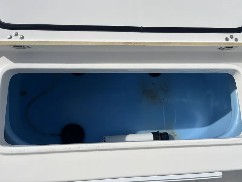 Slide: The Image of Open storage compartment of a 2014 Mako 21 LTS boat. - 25