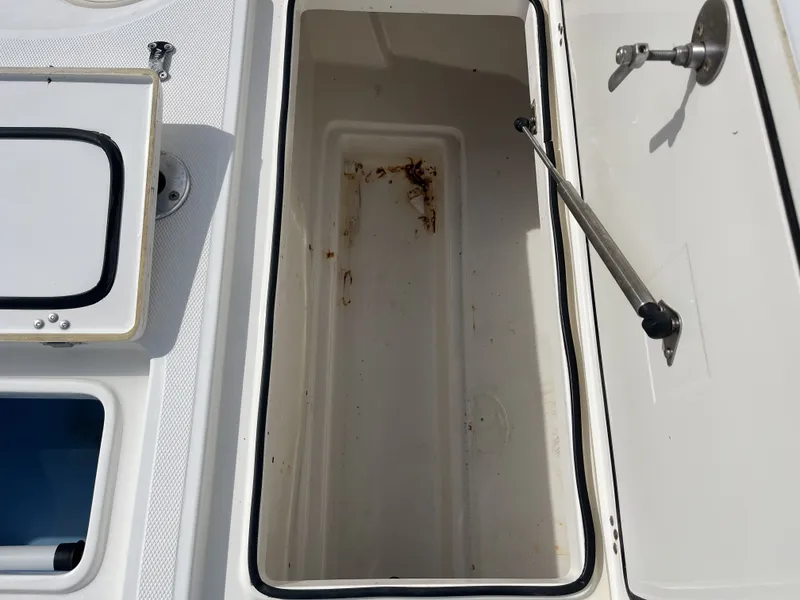 Slide: The Image of Open storage compartment on a 2014 Mako 21 LTS boat. - 26