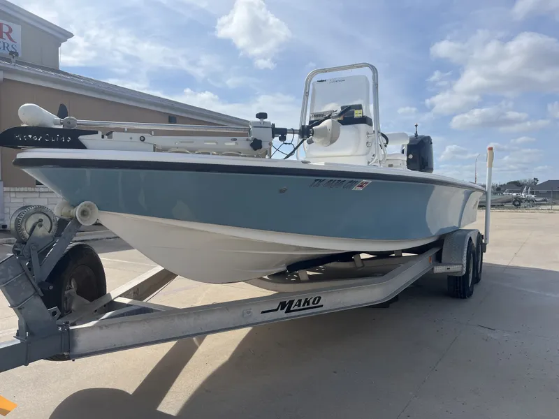 Slide: The Image of 2014 Mako 21 LTS boat on trailer, blue hull, sunny day. - 3