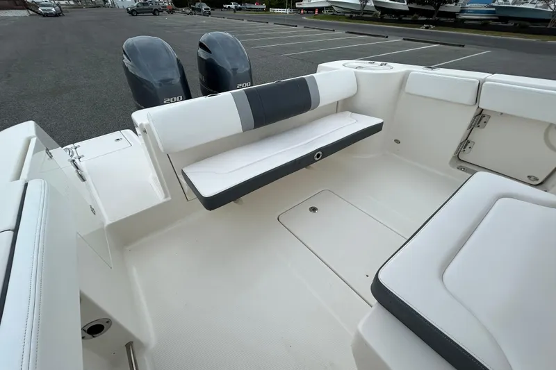 Slide: The Image of 2021 Robalo R272 Center Console boat interior with seating and dual engines. - 11