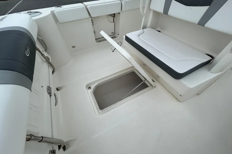 Slide: The Image of 2021 Robalo R272 Center Console boat interior with storage compartment and seating. - 13