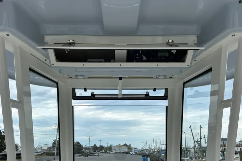 Slide: The Image of Interior view of 2021 Robalo R272 Center Console boat with open overhead compartment. - 17