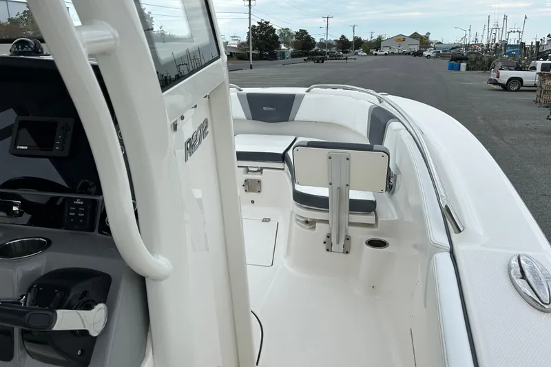 Slide: The Image of 2021 Robalo R272 Center Console boat interior with seating and control panel. - 19
