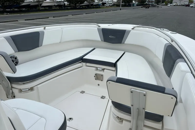 Slide: The Image of 2021 Robalo R272 Center Console boat interior with cushioned seating and storage. - 20