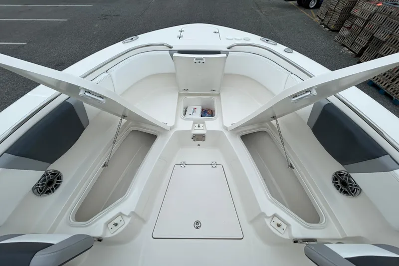 Slide: The Image of 2021 Robalo R272 Center Console boat with open storage compartments and seating area. - 21