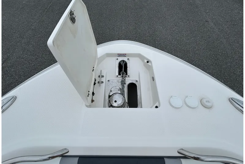Slide: The Image of 2021 Robalo R272 Center Console anchor compartment with open hatch on deck. - 22