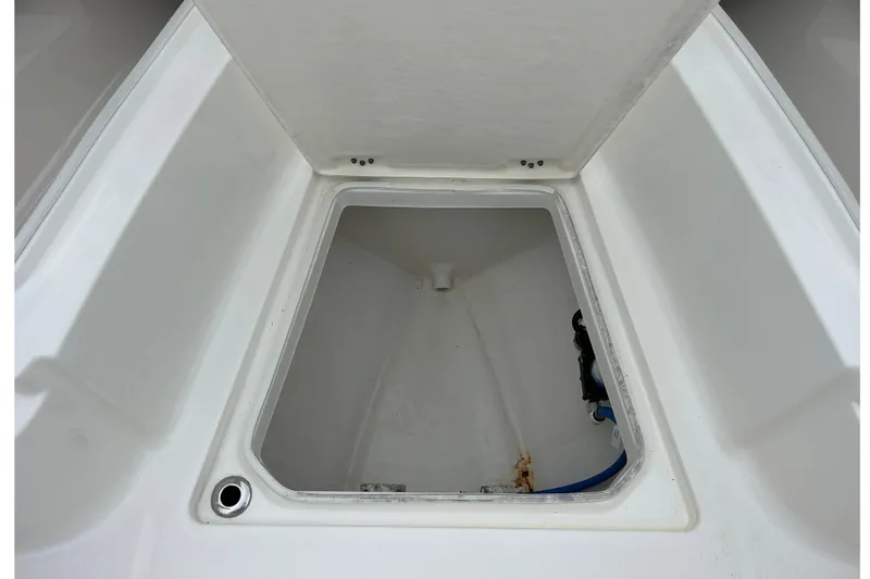 Slide: The Image of 2021 Robalo R272 Center Console storage compartment, open and empty. - 23