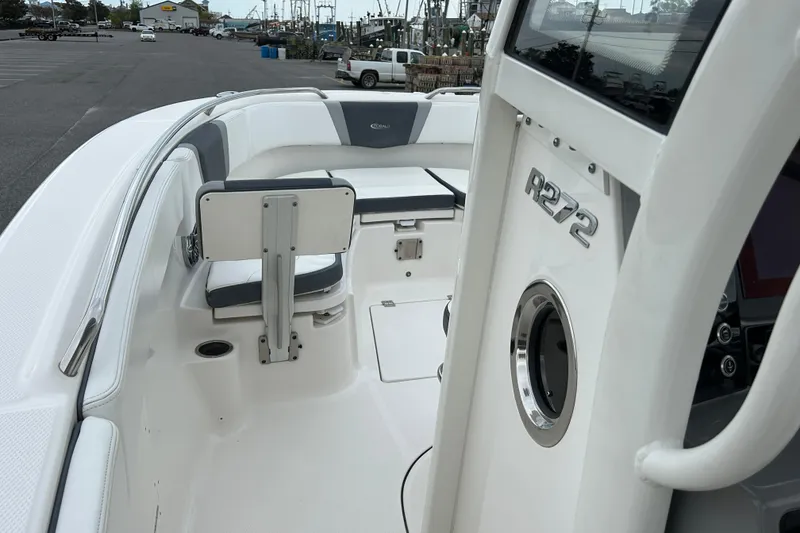 Slide: The Image of 2021 Robalo R272 Center Console boat interior with seating and console details. - 26