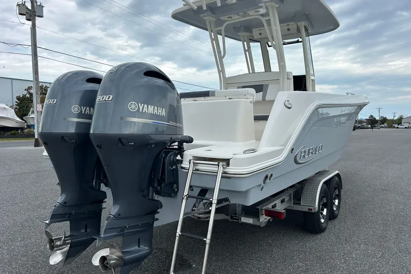 Slide: The Image of 2021 Robalo R272 Center Console boat with twin Yamaha 200 engines on a trailer. - 6