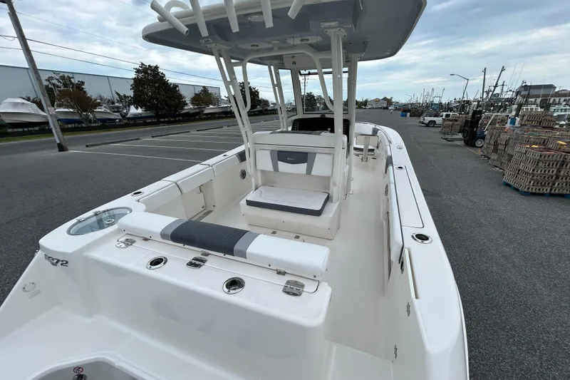 Slide: The Image of 2021 Robalo R272 Center Console boat docked, showcasing spacious seating and sleek design. - 7