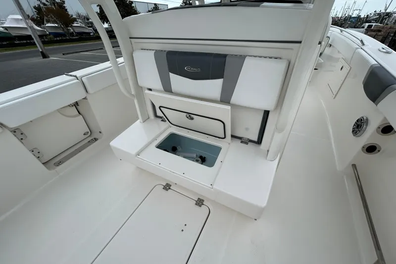 Slide: The Image of 2021 Robalo R272 Center Console boat interior with storage compartment open. - 9