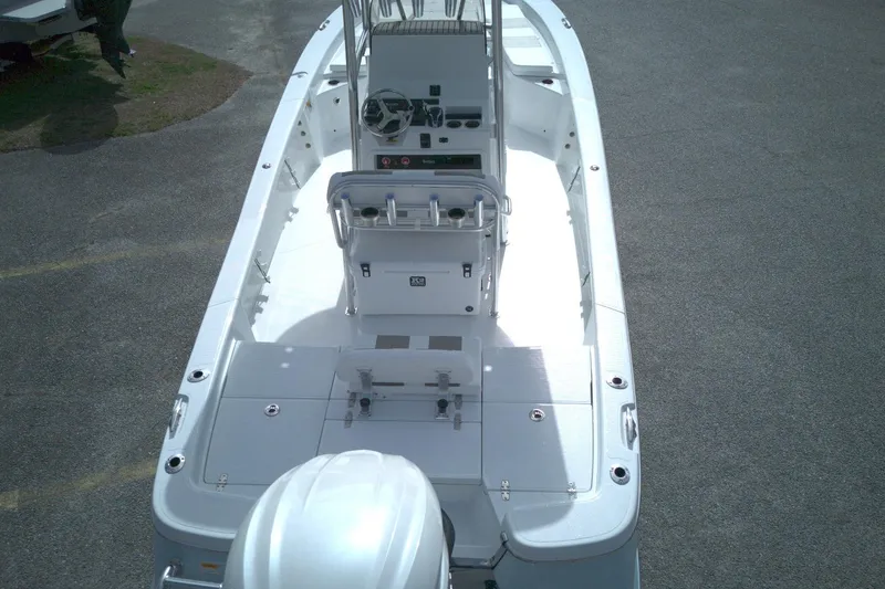 Slide: The Image of 2026 BlackJack 256 Bay boat interior, featuring helm and seating, viewed from above. - 11