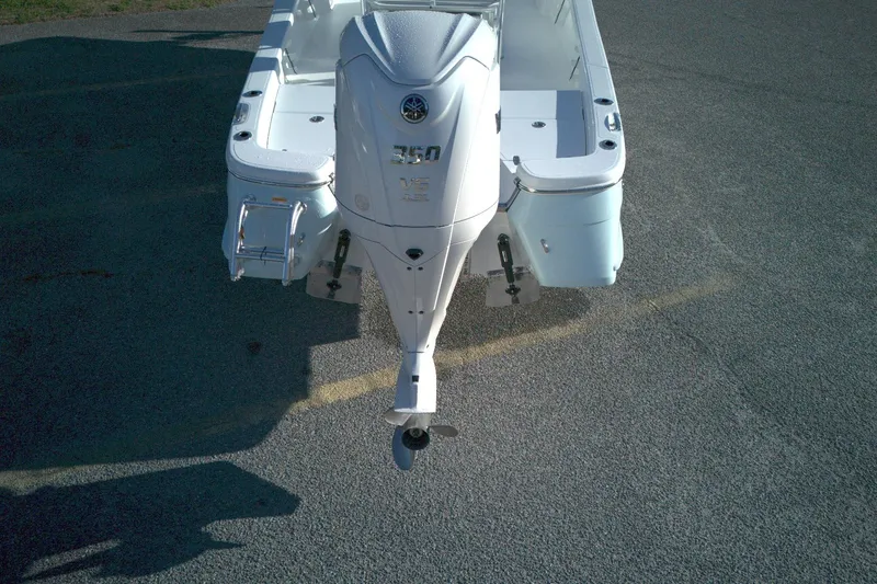 Slide: The Image of 2026 BlackJack 256 Bay boat with powerful outboard motor, viewed from above. - 2