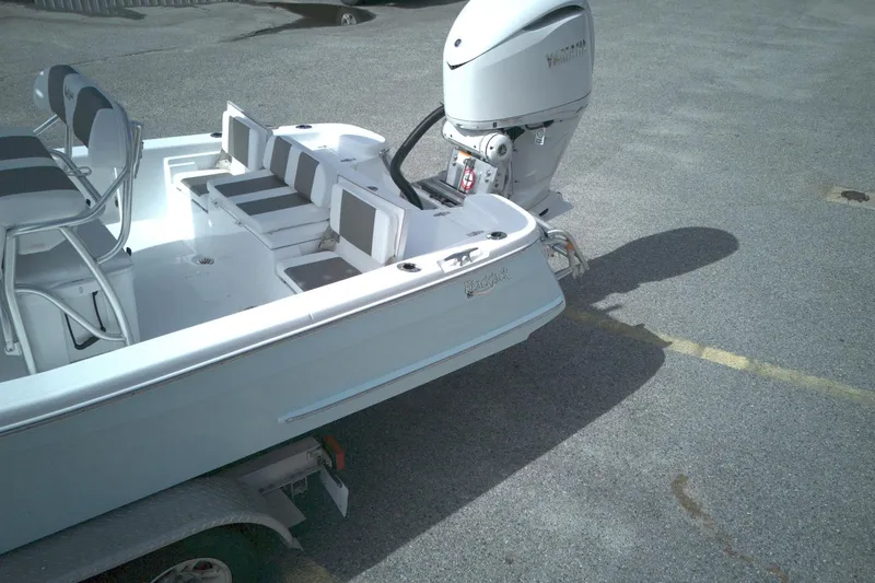 Slide: The Image of 2026 BlackJack 256 Bay boat with outboard motor on a trailer. - 8
