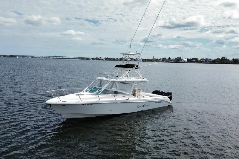The Image of 2008 Everglades 350LX boat on calm water under a cloudy sky. - 0