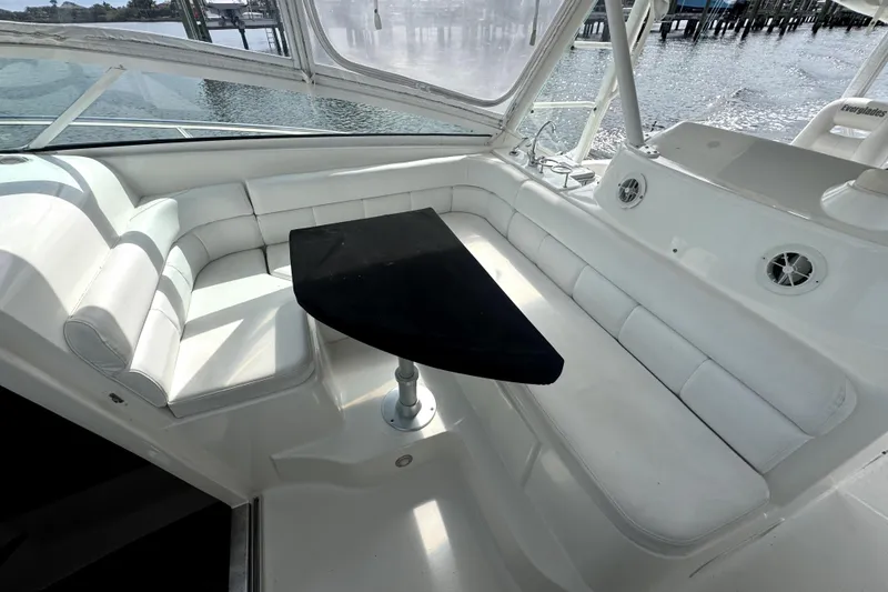 Slide: The Image of Luxurious seating area on 2008 Everglades 350LX boat with black table and white cushions. - 10
