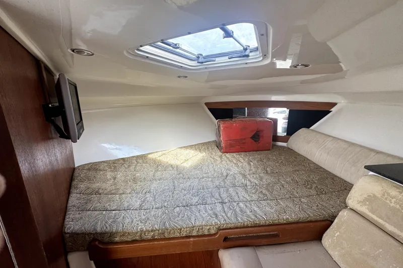 Slide: The Image of Cozy cabin interior of 2008 Everglades 350LX boat with patterned bedding and skylight. - 12