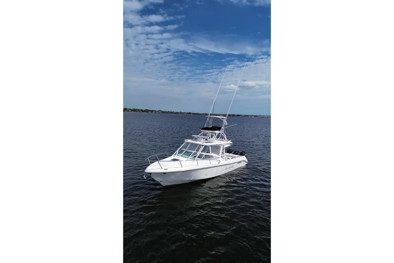 Slide: The Image of 2008 Everglades 350LX boat on calm water under a partly cloudy sky. - 3
