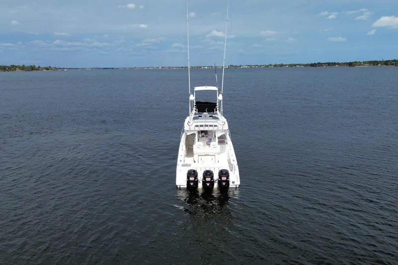 Slide: The Image of 2008 Everglades 350LX boat on open water, featuring triple outboard engines. - 4