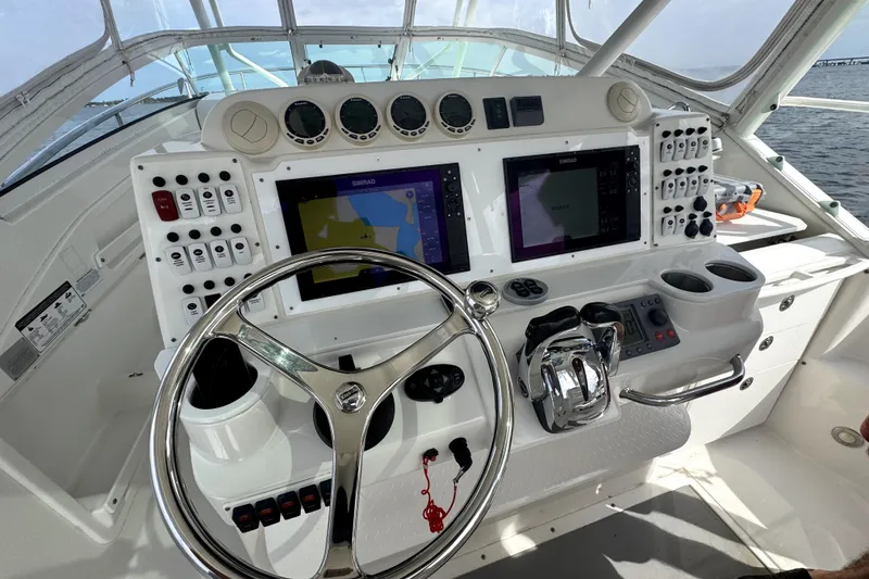 Slide: The Image of Cockpit of 2008 Everglades 350LX boat with advanced navigation controls and dual displays. - 6