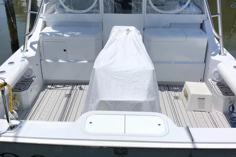 Slide: The Image of 1995 Cabo 35 Express boat deck with covered seating and storage compartments. - 10