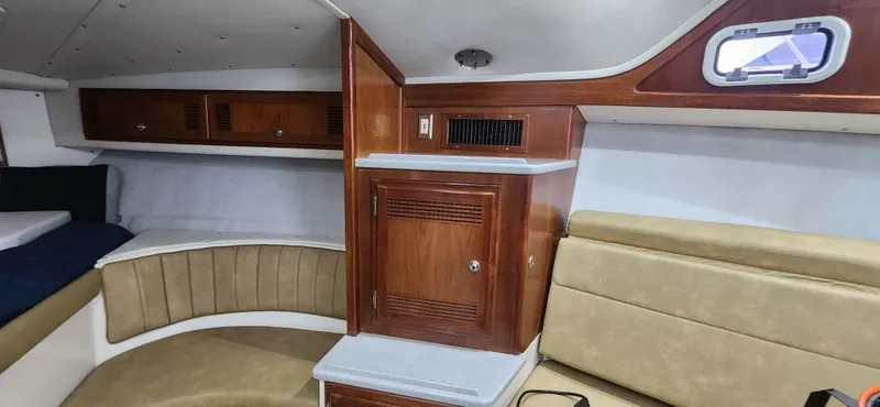 Slide: The Image of Interior of 1995 Cabo 35 Express boat with wood cabinetry and seating. - 23