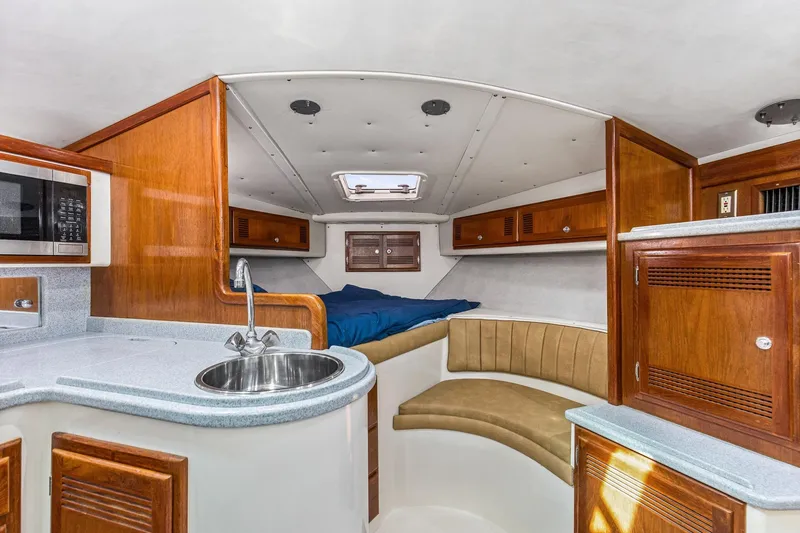 Slide: The Image of Interior of 1995 Cabo 35 Express boat with kitchenette and sleeping area. - 32