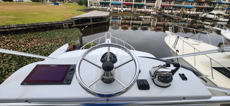 Slide: The Image of Helm of 1995 Cabo 35 Express boat with steering wheel and navigation equipment. - 37