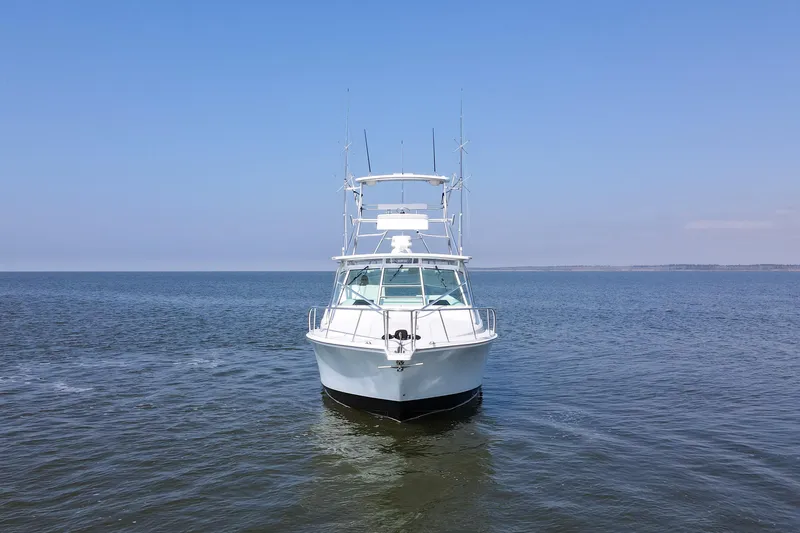 Slide: The Image of 1995 Cabo 35 Express boat on calm ocean under clear blue sky. - 4