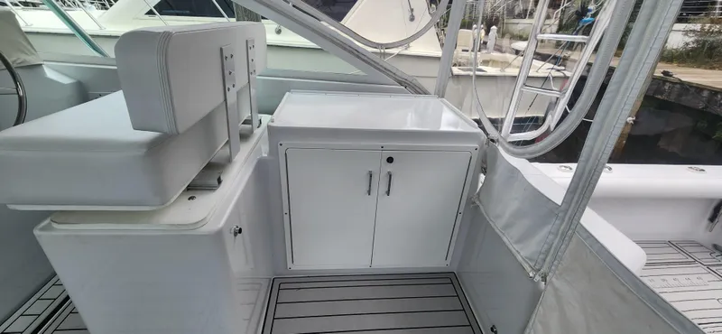 Slide: The Image of 1995 Cabo 35 Express boat interior with seating and storage cabinet. - 43