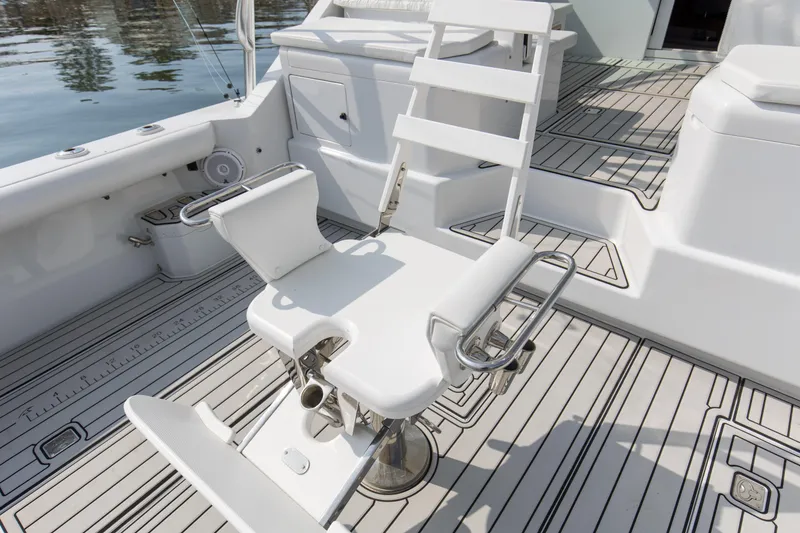 Slide: The Image of Fishing chair on 1995 Cabo 35 Express boat deck, featuring sleek white design and sturdy construction. - 57