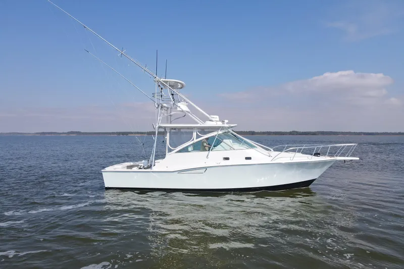 Slide: The Image of 1995 Cabo 35 Express boat on calm water under clear sky. - 66