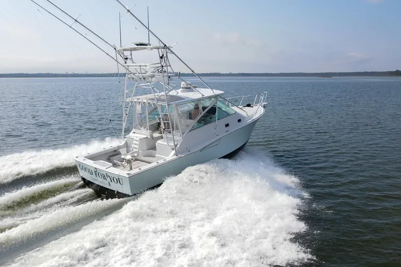 Slide: The Image of 1995 Cabo 35 Express boat cruising on open water, rear view. - 70
