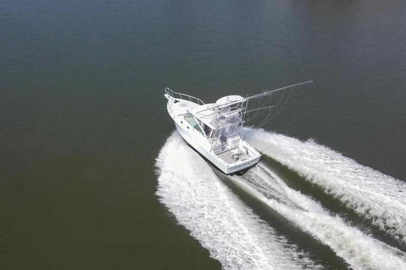 Slide: The Image of 1995 Cabo 35 Express boat cruising on calm water, aerial view. - 71