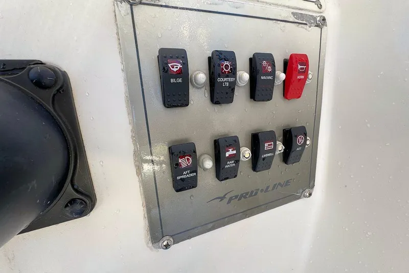 Slide: The Image of Control panel on a 2000 Pro-Line 22 Walkaround boat with labeled switches. - 10