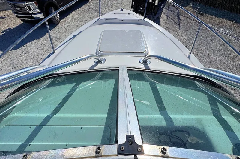 Slide: The Image of 2000 Pro-Line 22 Walkaround boat deck and windshield view in a parking area. - 13