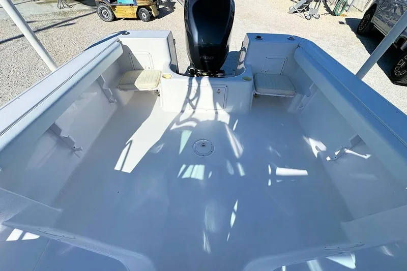 Slide: The Image of 2000 Pro-Line 22 Walkaround boat interior with seating and motor, viewed from above. - 5