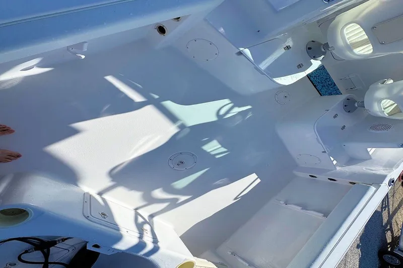 Slide: The Image of 2000 Pro-Line 22 Walkaround boat interior, showcasing spacious white deck and seating area. - 7