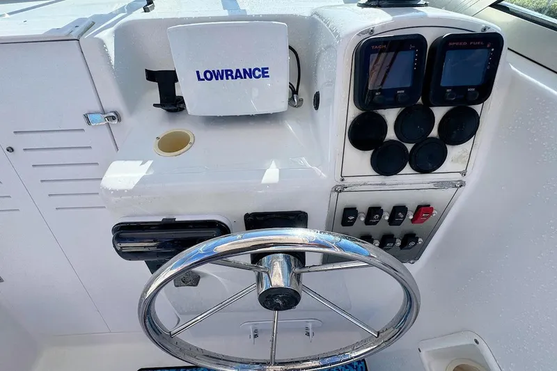 Slide: The Image of 2000 Pro-Line 22 Walkaround boat dashboard with steering wheel and Lowrance navigation system. - 9