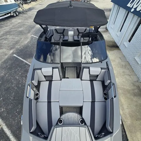 Slide: The Image of 2025 Yamaha Boats 222XE with luxurious interior and black canopy. - 17