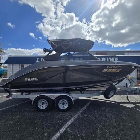Slide: The Image of 2025 Yamaha Boats 222XE on trailer under blue sky. - 3