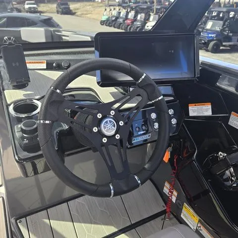 Slide: The Image of Yamaha Boats 222XE 2025 helm with steering wheel and display. - 8