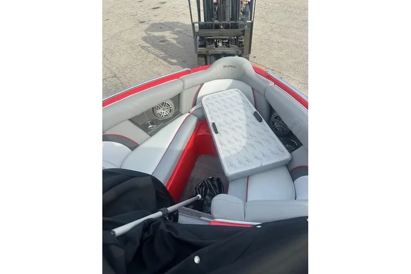 Slide: The Image of 2011 Supra Launch 242 boat interior with seating and table, featuring red and gray accents. - 11