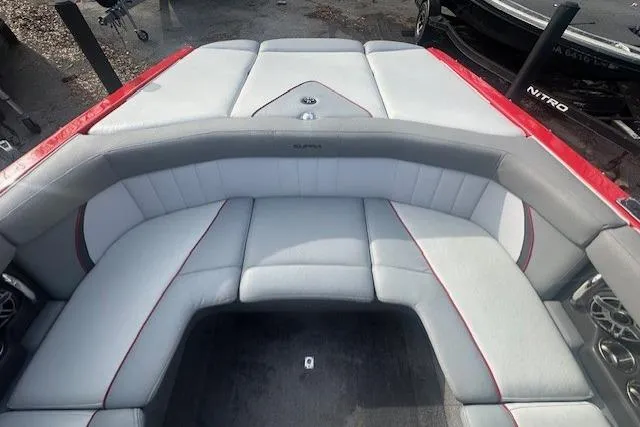 Slide: The Image of 2011 Supra Launch 242 boat interior with gray and red seating. - 15