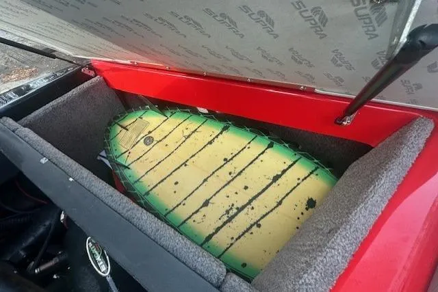 Slide: The Image of 2011 Supra Launch 242 storage compartment with a colorful surfboard inside. - 16