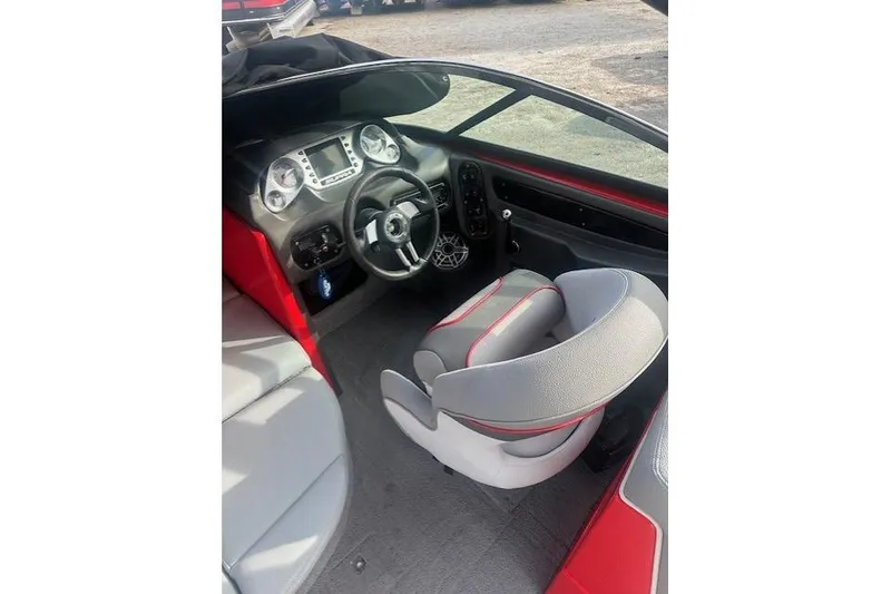 Slide: The Image of 2011 Supra Launch 242 boat interior with steering wheel and dashboard. - 17