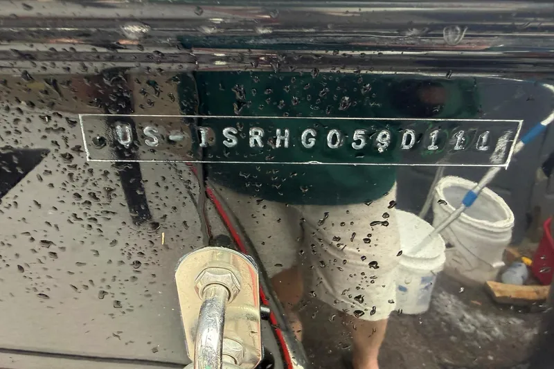 Slide: The Image of 2011 Supra Launch 242 boat hull identification number with water droplets. - 18