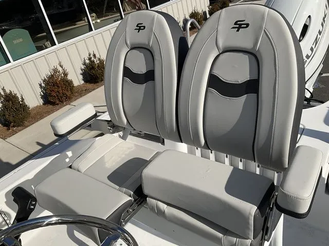 Slide: The Image of 2026 Sea Pro 230 Bay Boat with gray seats and steering wheel. - 13